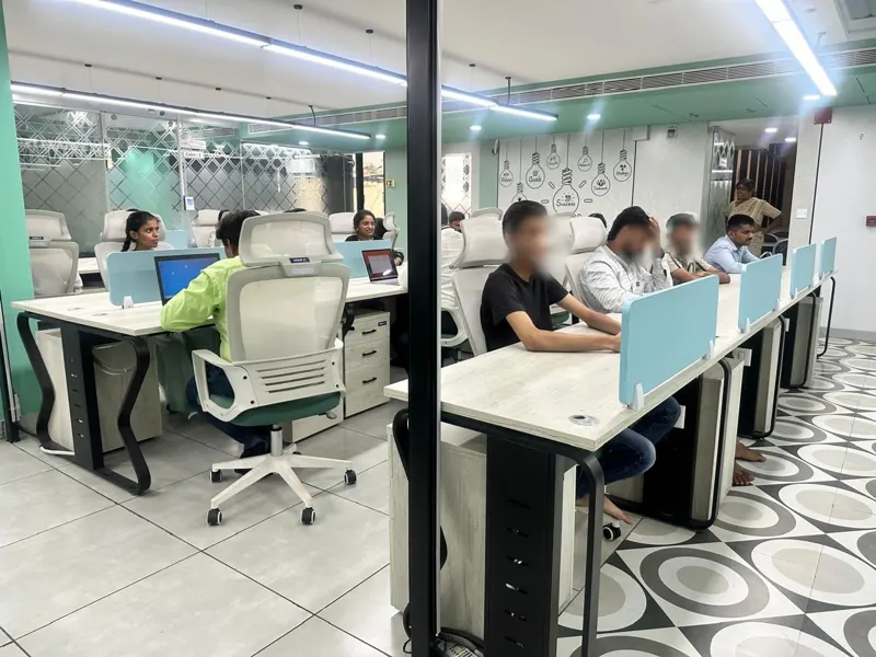 Open co-working desks with blue dividers