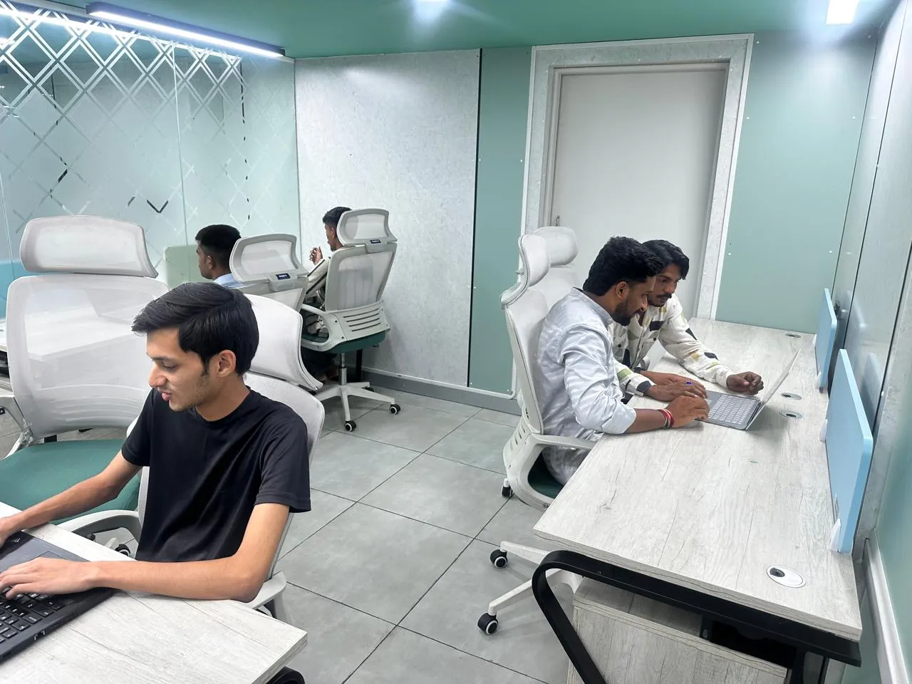 Team members working at desks inside a private cabin at Mehta Biz Space, Bengaluru